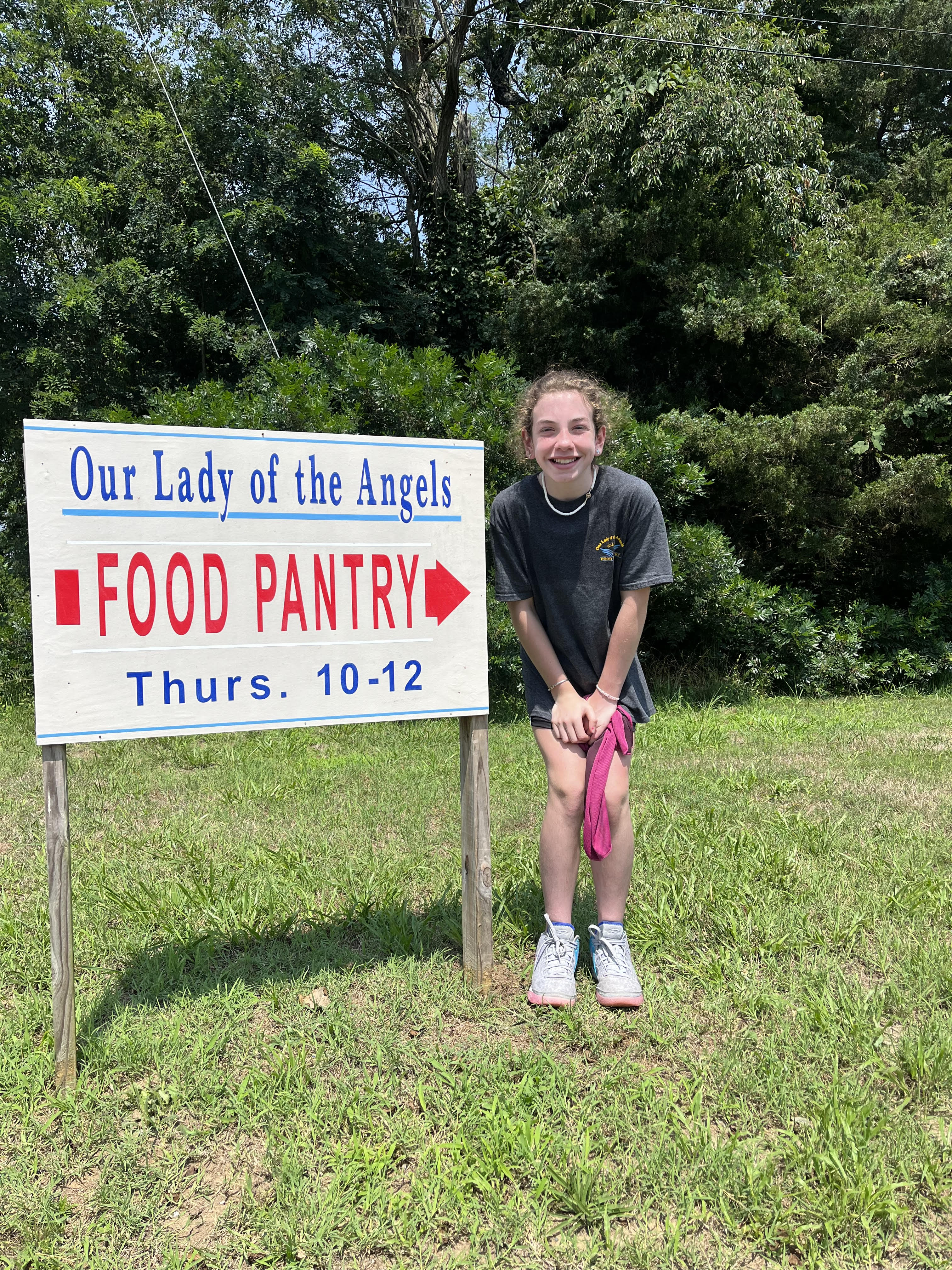 Brooklynn Alessandroni outside Our Lady of Angels food pantry